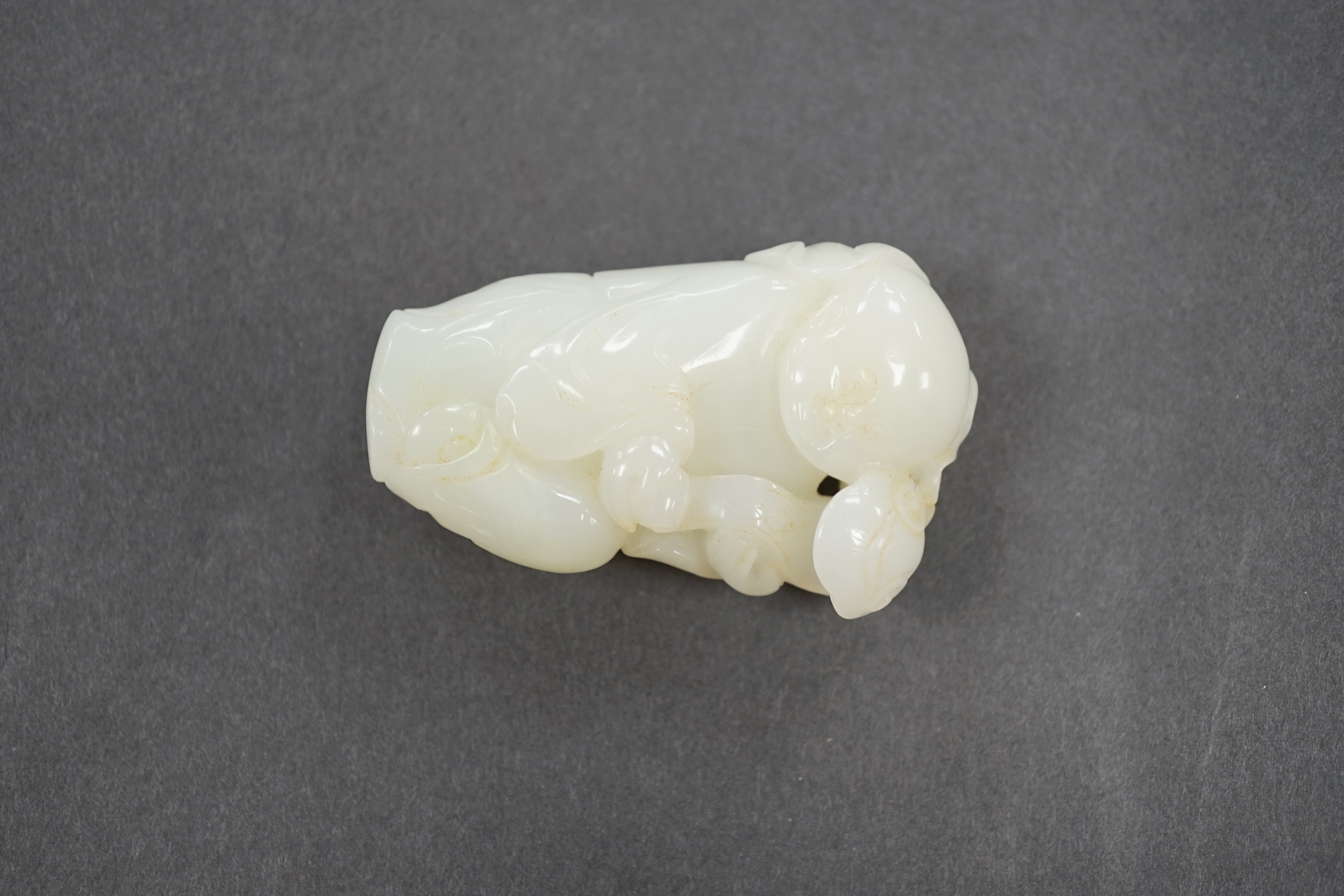 A Chinese white jade boy with ruyi sceptre, 7cm
